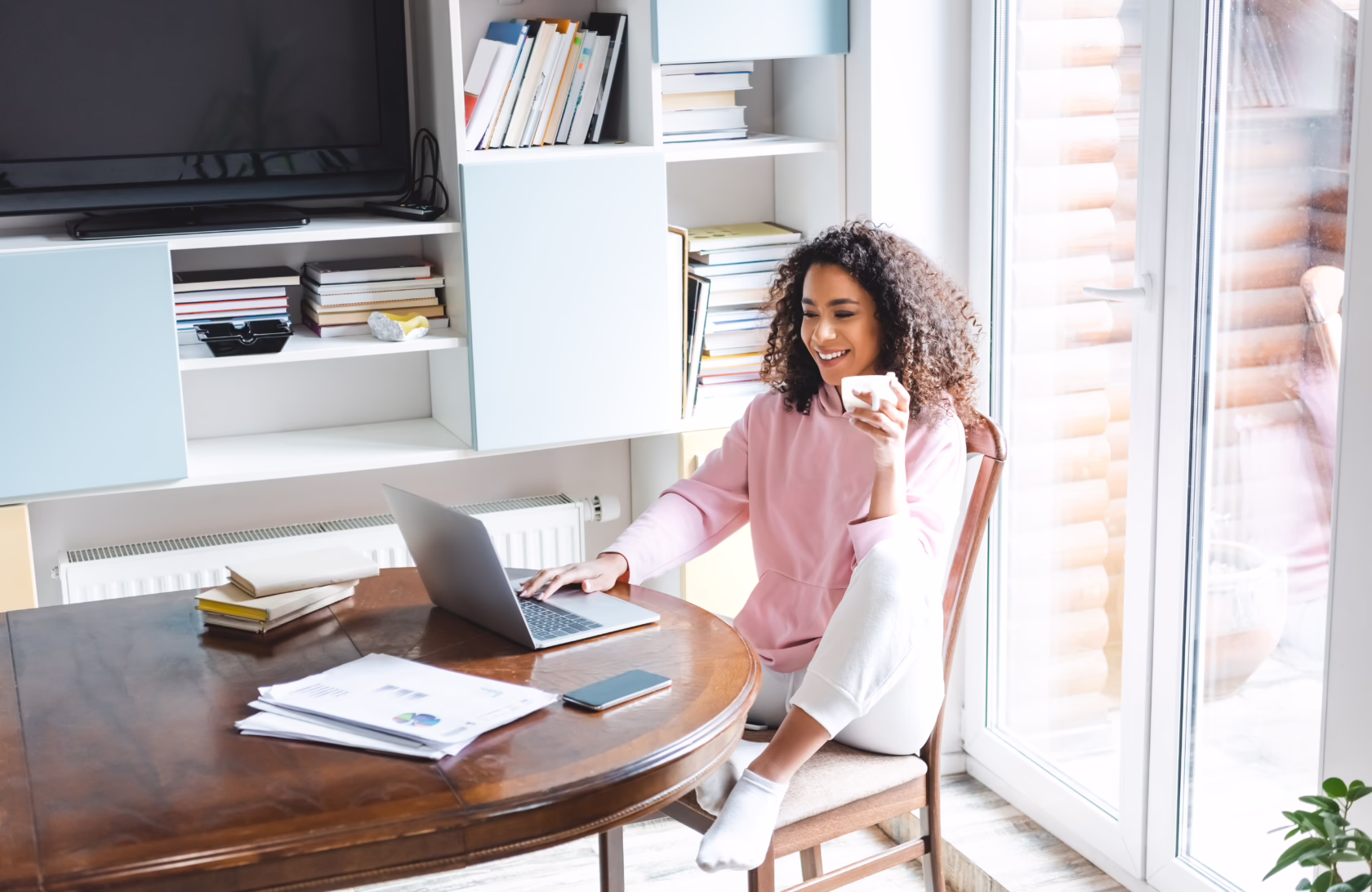 Adult student completing coursework online from home using a laptop, illustrating a flexible path to earning a high school diploma online.