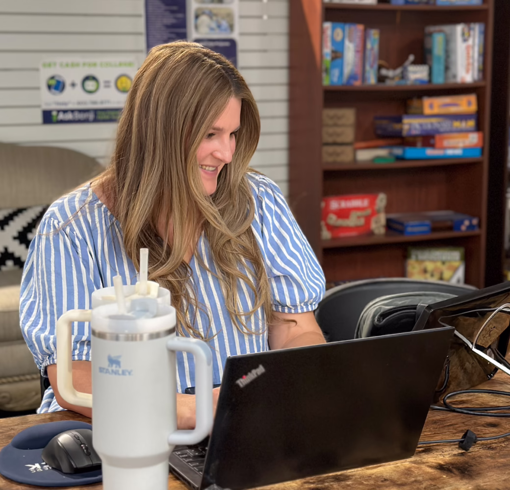 An adult learner sits at their computer working on assignments at a HUB resource center